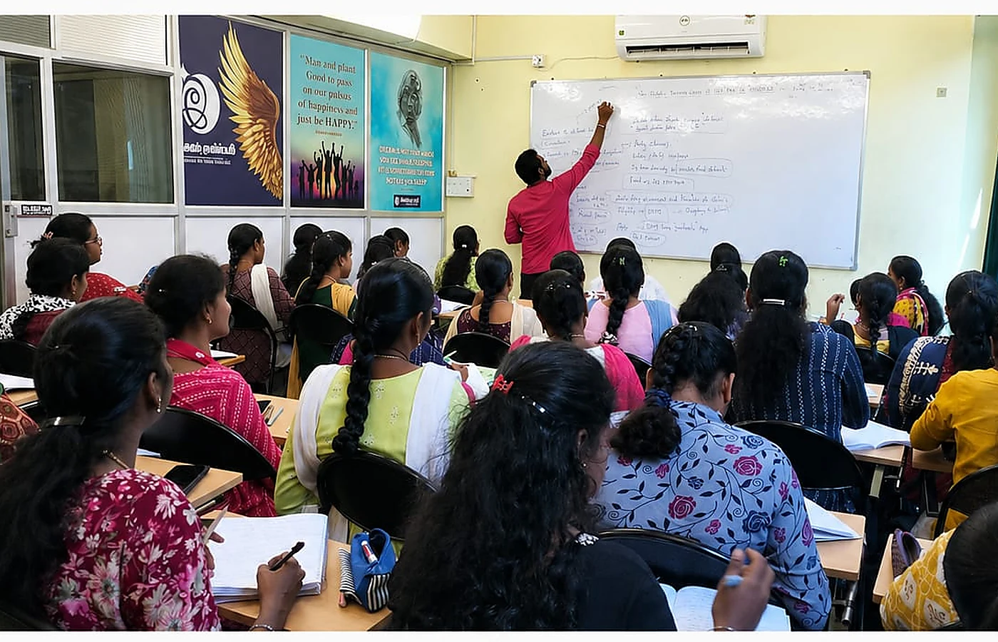 Trainer teaching students at Ilampirai Academy